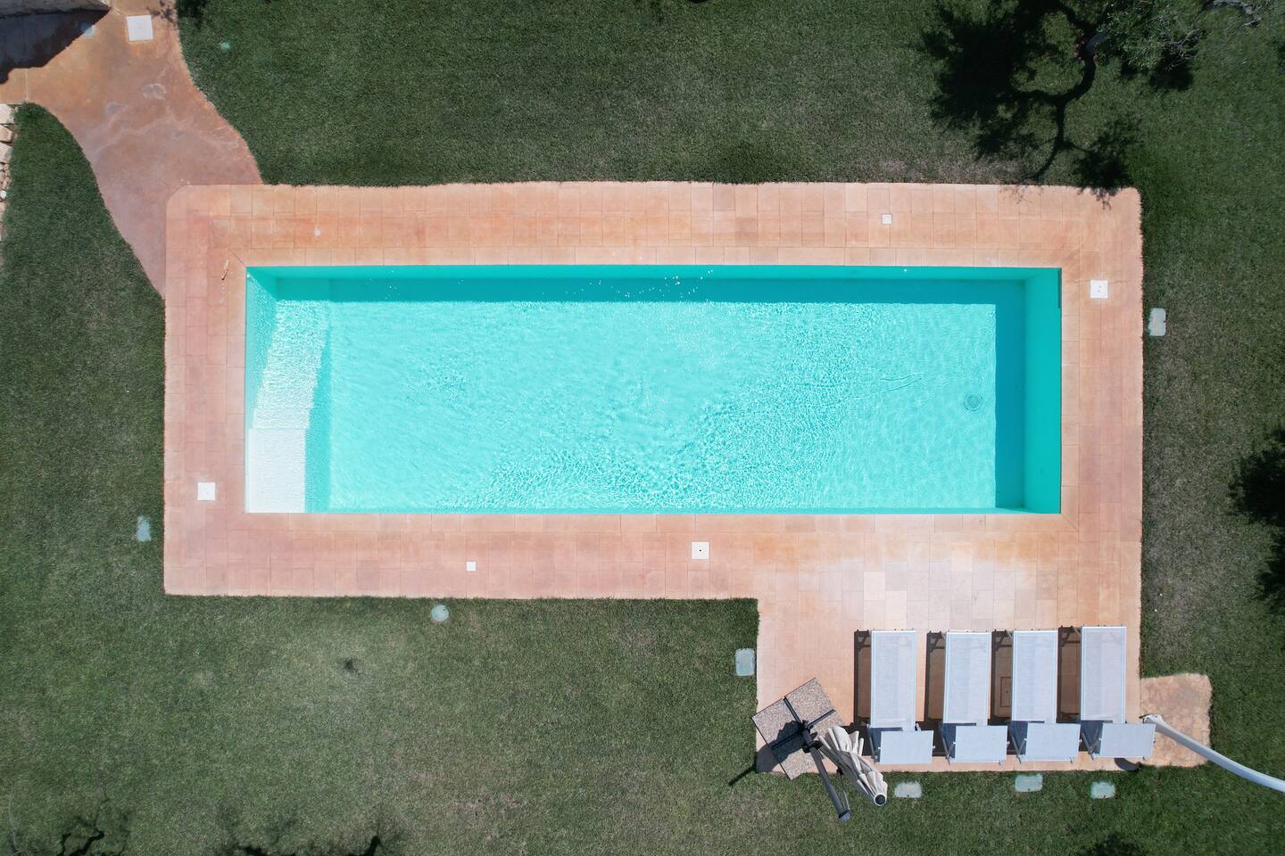The 40m2 pool at Villa El Carmen surrounded by loungers