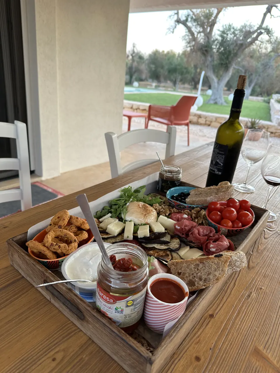 Aperitivo board with wine on the terrace