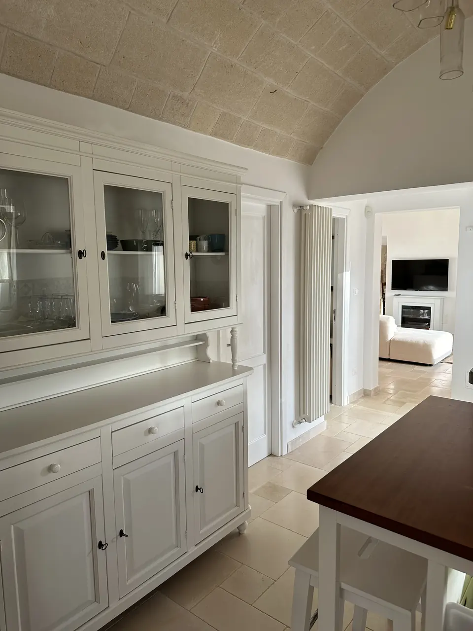 Kitchen with vaulted ceiling and white cabinets