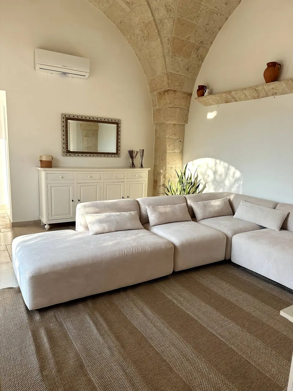 Living room with sofa under a vaulted stone ceiling